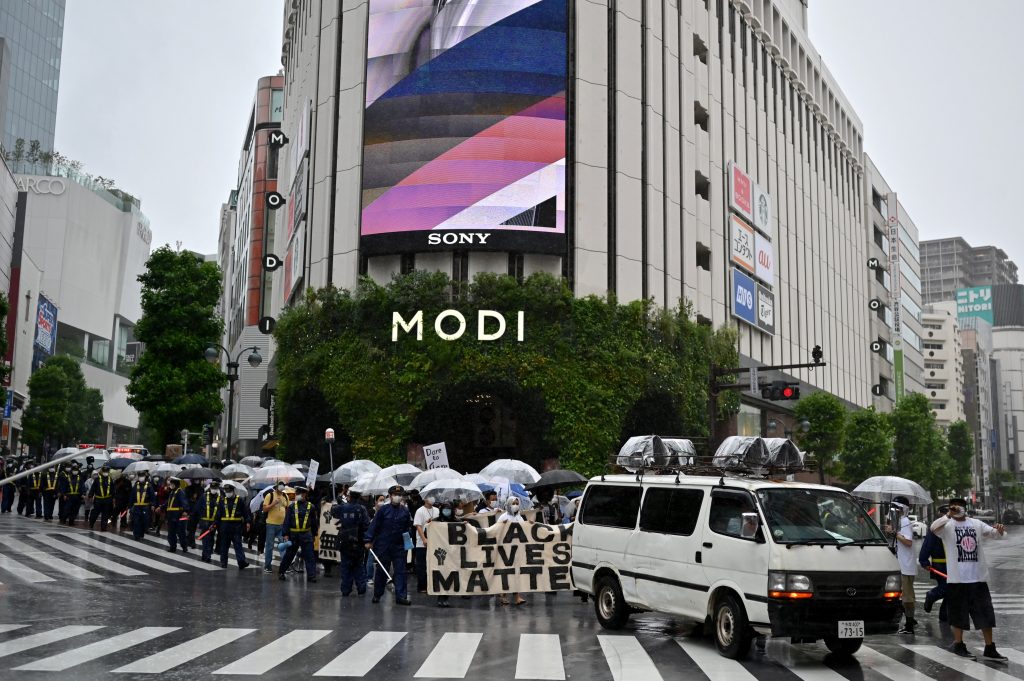 Activists take part in a march in support of the 'Black Lives Matter' protests sweeping the US, in central Tokyo on June 13, 2020. (AFP)