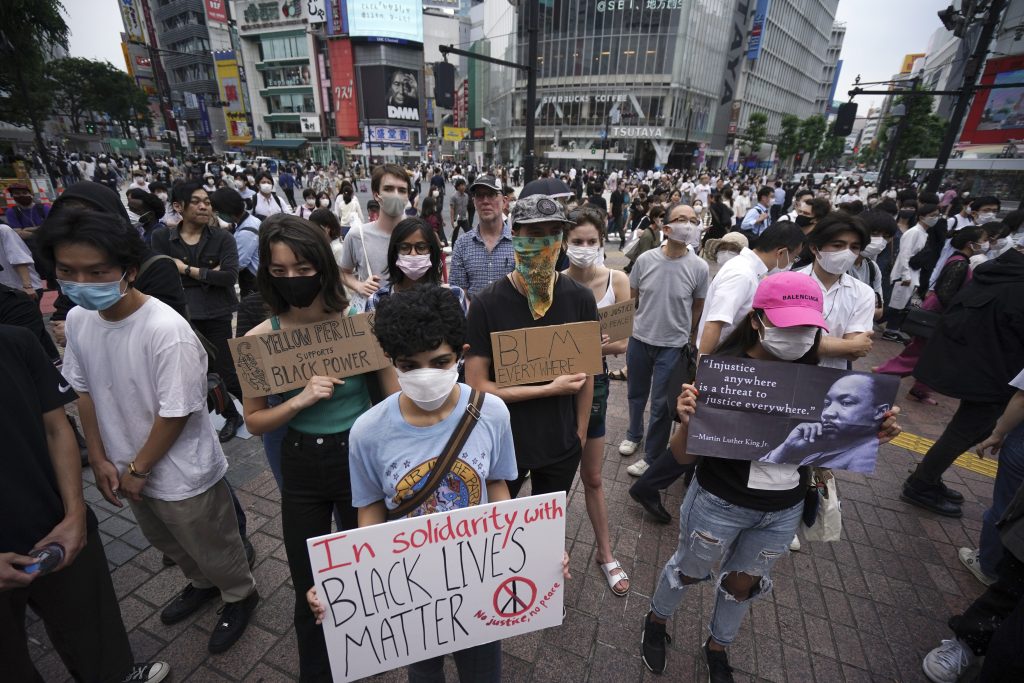 Protestors marched through the Shibuya and Ebisu districts in central Tokyo. (AP)