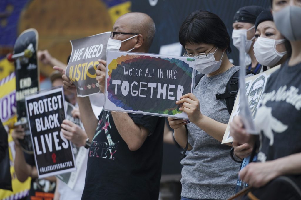 Protestors marched through the Shibuya and Ebisu districts in central Tokyo. (AP)