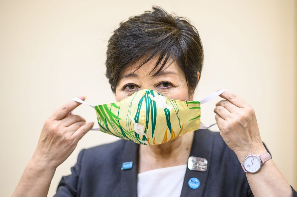 This picture taken on June 12, 2020 shows Tokyo governor Yuriko Koike posing for a photo with a Hawaiian face mask, a gift from the mayor of Honolulu, after an interview with AFP at the Tokyo Metropolitan Government building. Next year's Olympics will be safe despite the coronavirus pandemic, Tokyo Governor Yuriko Koike said, pledging a 