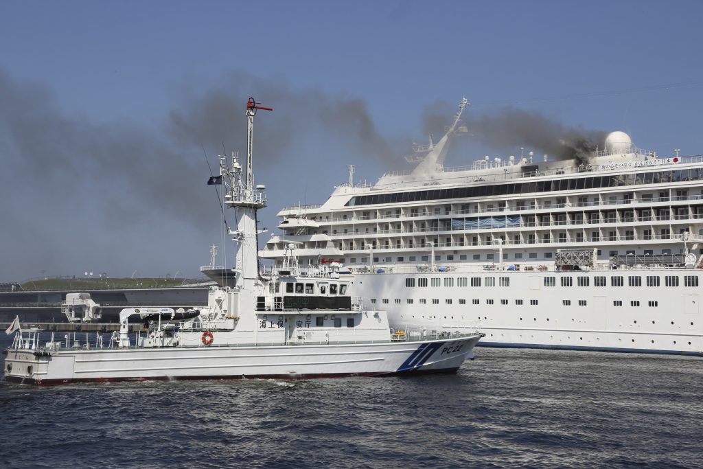 Smoke rises from Japanese cruise ship Asuka II docked in Yokohama Port, in Yokohama near Tokyo, June 16, 2020. (File photo/AP)