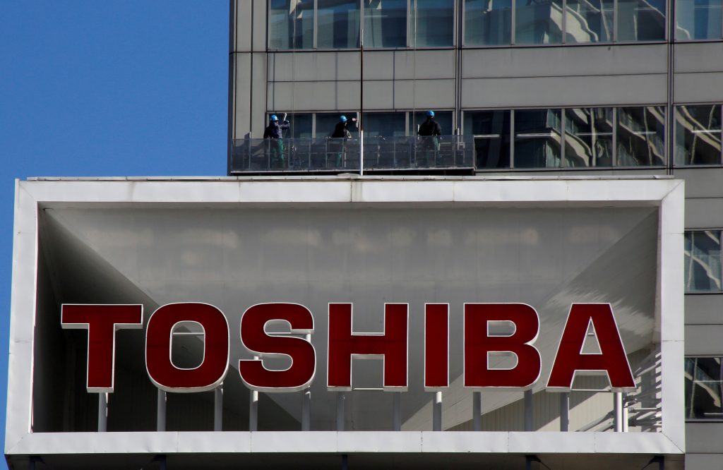  Logo of Toshiba Corp is seen as Window cleaners work on the company's headquarters in Tokyo. (File photo/Reuters)