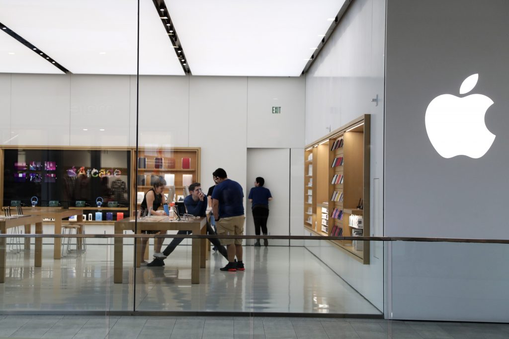 Apple employees work inside a closed Apple store in Miami as the company temporarily closes 11 stores in the US just few weeks after reopening them due to fears over the spread of coronavirus COVID-19. (File photo/AP)