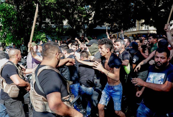 Lebanese army block supporters of the Lebanese Shiite movements Hezbollah and Amal as they shout slogans against protesters in central Beirut. (AFP/Anwar Amro)