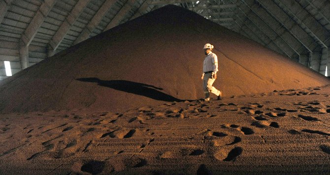 An employee walks in a phosphate storage facility in the Maaden Aluminium Factory in Ras Al-Khair Industrial area near Jubail City. (File/AFP)