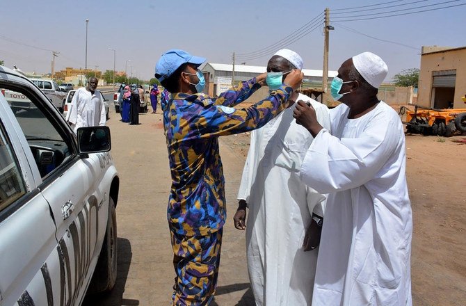 United Nations African Union Mission in Darfur peacekeepers provide masks and hand sanitizers to local population El-Fasher in North Darfur of Sudan. (UNAMID via AP)