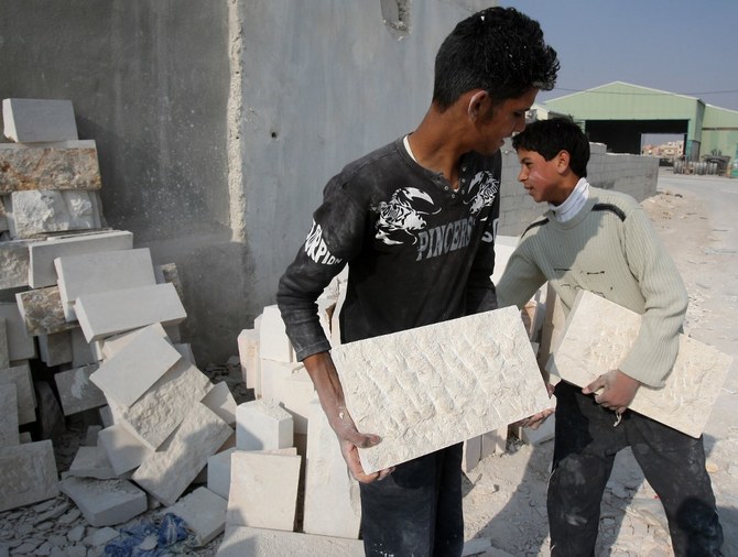 Jordanian teenagers work at a stone cutting workshop in the inudstrial area of Sahab, 40 kms south of Amman, on December 22, 2008. (File/AFP)