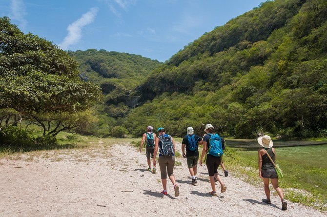A group of hikers in the green wadis of Salalah, Oman. (Shutterstock)