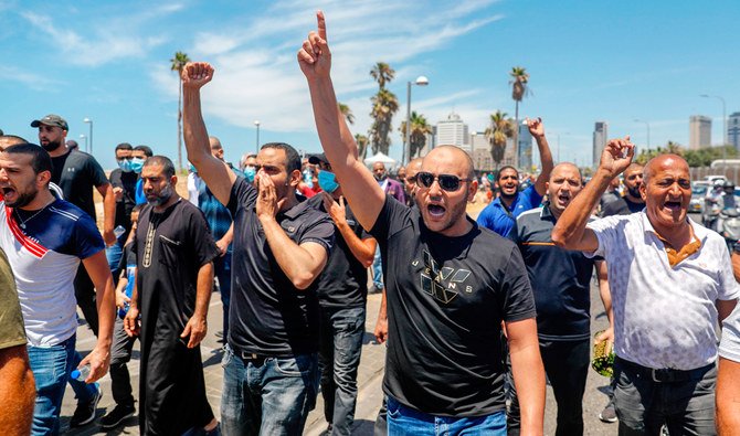 Protesters take to the streets of the Israeli coastal city of Jaffa, south of Tel Aviv, following the Friday noon prayers, to protest against an Israeli decision to demolish an 18th century Muslim burial ground to build a new homeless shelter and commercial space on the site. (AFP)