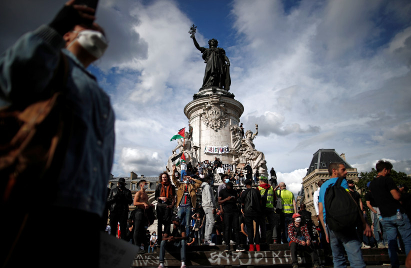 Palestinian flags fly at a Black Lives Matter protest in the Place de la Republique, Paris, France, June 13, 2020. (Reuters)