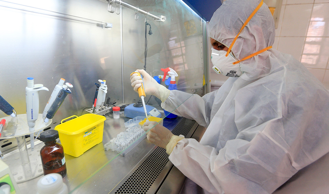 A lab technician wearing full PPE (personal protective equipment) runs a test to detect whether a person has been infected with COVID-19 at the Central Health Laboratory in the Yemeni capital Sanaa, on June 14, 2020. (AFP)