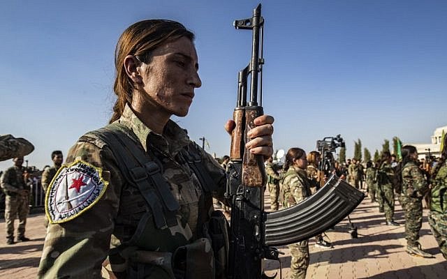 Mourners attend a funeral, for Kurdish political leader Hevrin Khalaf and others including civilians and Kurdish fighters, in the northeastern Syrian Kurdish town of Derik, known as al-Malikiyah in Arabic, on October 13, 2019 (AFP file photo)