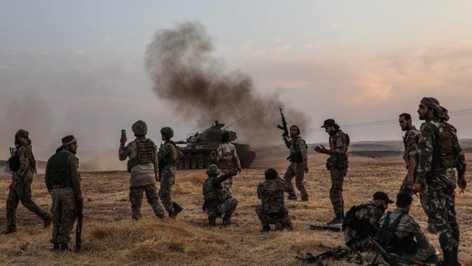 Turkish soldiers and Turkey-backed Syrian fighters gather on the northern outskirts of the Syrian city of Manbij in late 2019. (AFP)