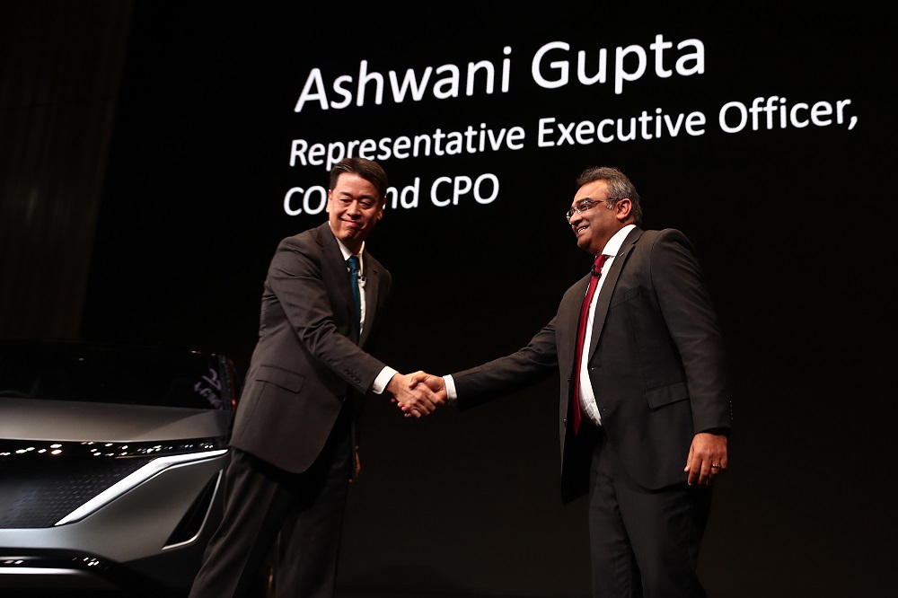 Nissan Motor's Makoto Uchida (left) shakes hands with Ashwani Gupta as they attend a press conference at the company's headquarters in Yokohama on December 2, 2019. (AFP)
