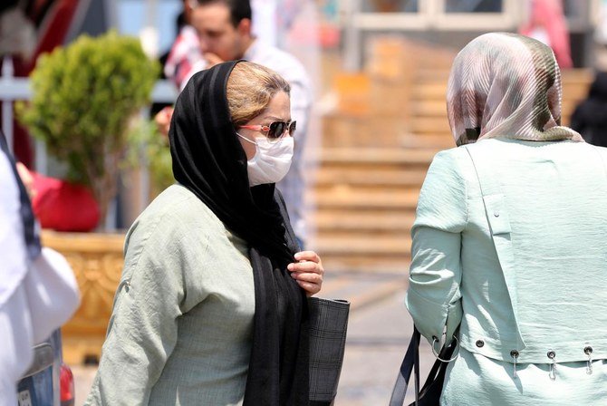 A pedestrian wearing a protective mask due to the COVID-19 coronavirus, walks along a street in the Iranian capital Tehran on June 28, 2020. (AFP)