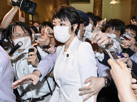 Japan's upper house lawmaker Anri Kawai, the wife of former Japanese Justice Minister Katsuyuki Kawai, is surrounded by reporters in Tokyo, Japan, on June 17, 2020. (Kyodo/via Reuters)