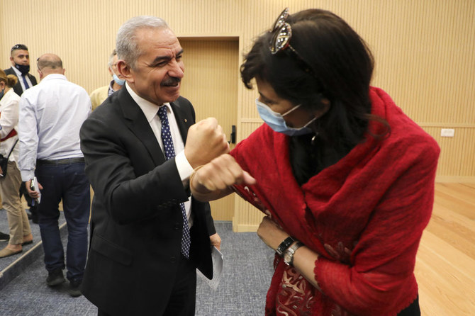 Palestinian PM Mohammad Shtayyeh greets a journalist with an elbow bump following a meeting with members of the Foreign Press Association in Ramallah, West Bank, June 9, 2020. (Reuters)