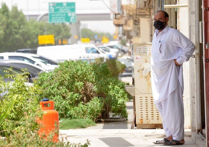 A mask-clad labourer stands outside his workplace in the Saudi capital Riyadh on June 6, 2020, as lockdown measures are eased amid the COVID-19 pandemic. (AFP)