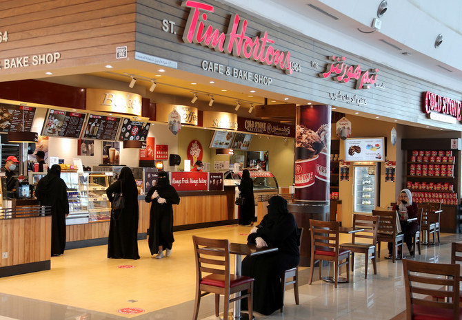 People sit at the Hayat mall coffee shop court after restaurants and malls reopened as the government eased the coronavirus lockdown restrictions, in Riyadh, Saudi Arabia June 1, 2020. (Reuters)