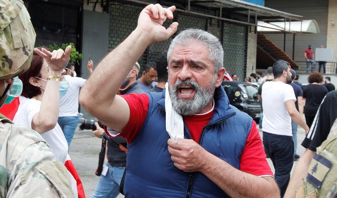 A Lebanese demonstrator gestures during a protest against the collapsing Lebanese pound currency and price hikes, in Zouk, north of Beirut, Lebanon, April 27, 2020. (REUTERS)