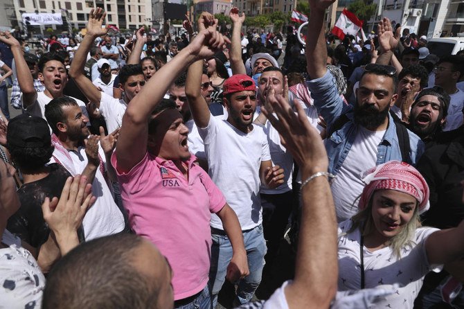 Anti-government protesters shout slogans during a protest in downtown Beirut, Lebanon, Saturday, June 6, 2020. (AP)