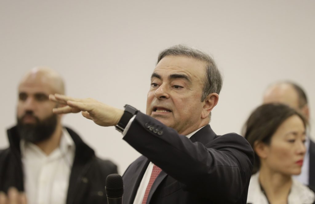 Former Renault-Nissan boss Carlos Ghosn answers journalists' questions as he addresses a large crowd of journalists on his reasons for dodging trial in Japan, where he is accused of financial misconduct. (AFP)
