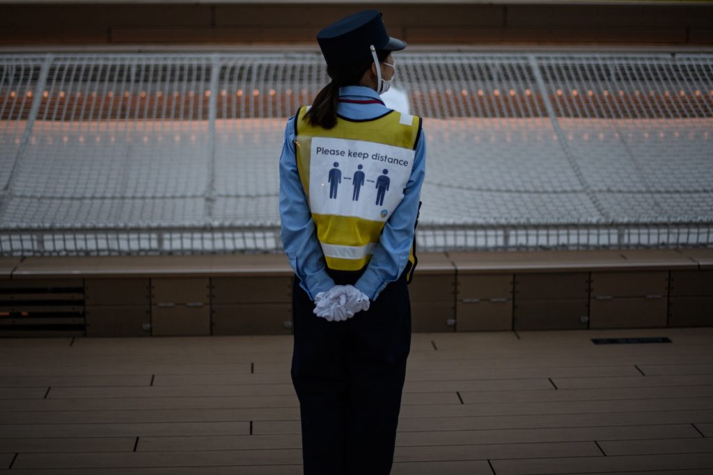 A security guard with a vest of showing a notice of 