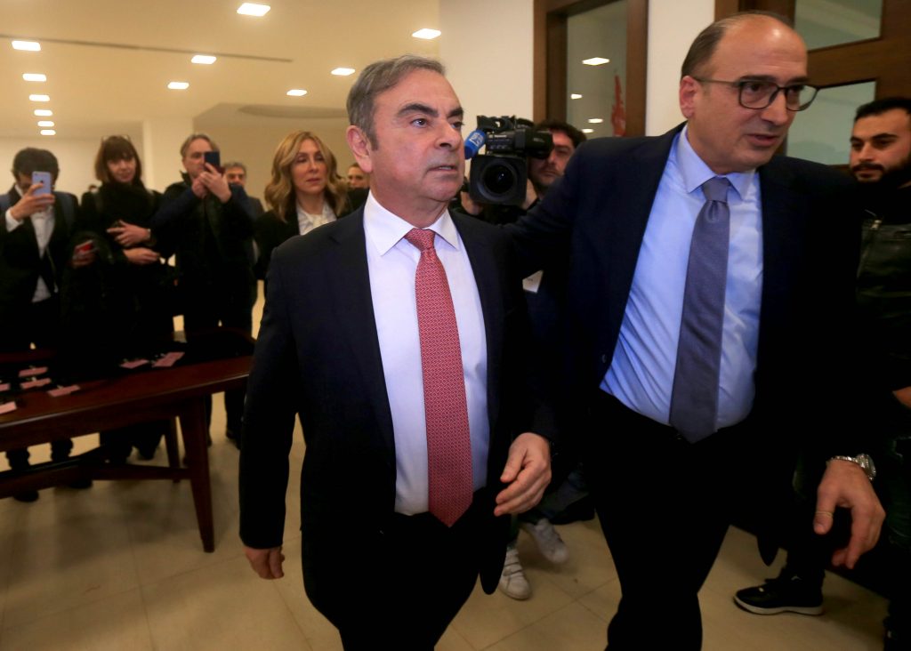 In this file photo taken on January 08, 2020 Former Renault-Nissan boss Carlos Ghosn (L) arrives at the Lebanese Press Syndicate to address a large crowd of journalists on his reasons for dodging trial in Japan, where he is accused of financial misconduct, in Beirut. (AFP)