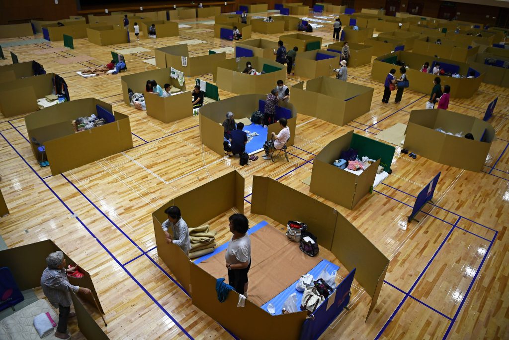 Local residents take shelter at an evacuation centre with space to maintain social distance in Yatsushiro city general gymnasium, Kumamoto prefecture, on July 6, 2020. (AFP)