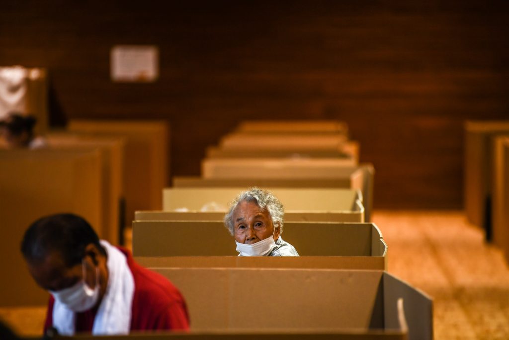 An increasing number of Japanese companies are developing cardboard products used as partitions at shelters. (AFP)