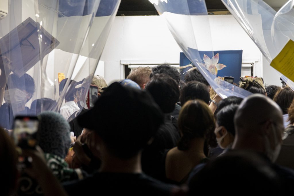 In this picture taken on July 9, 2020, crowds rush inside Same gallery as they grab artworks of a stealable art exhibition organised by the gallery in Tokyo. (AFP)