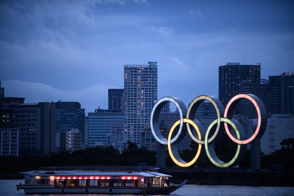 A Japanese houseboat, also known as yakatabune, sails past the Olympic Rings as seen from Odaiba Seaside Park in Tokyo on July 12, 2020. (AFP)