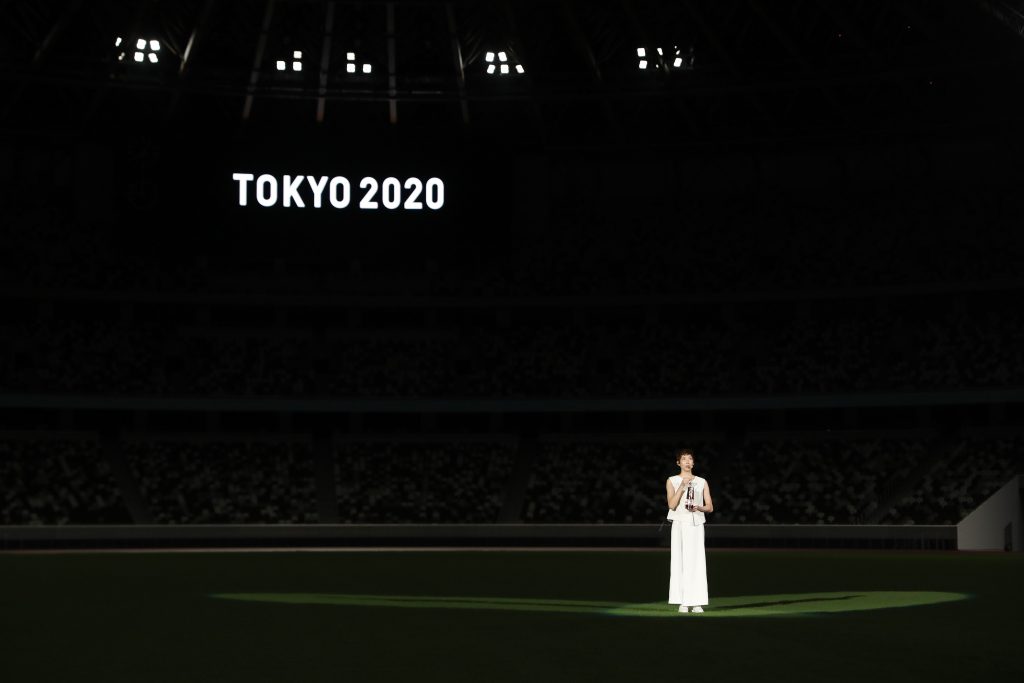 Japanese swimmer Rikako Ikee speaks while holding a lantern containing the Olympic flame during an event to mark one year until the postponed Tokyo 2020 Olympic and Paralympic Games at the National Stadium in Tokyo on July 23, 2020. (AFP)