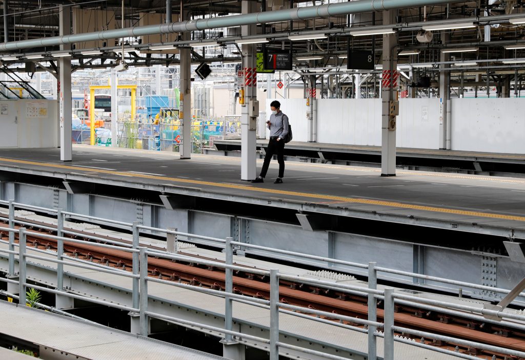 A man wearing a protective mask amid the coronavirus disease (COVID-19) outbreak, waits for a train at a railway station in Tokyo, Japan, July 3, 2020. (Reuters)