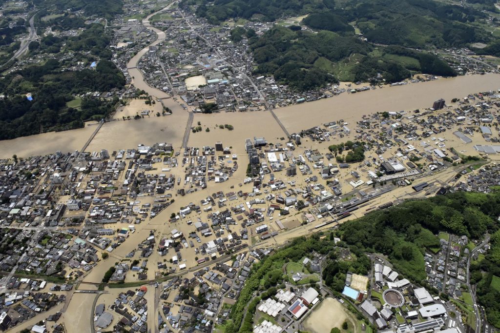 Areas are inundated in muddy waters that gushed out from the Kuma River in Hitoyoshi, Kumamoto prefecture, southwestern Japan, July. 4, 2020. (Kyodo News via AP)