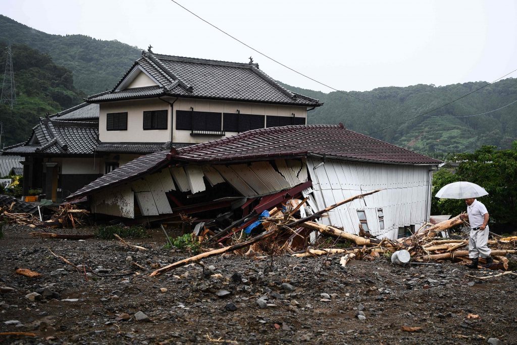A man walks in a landslide site caused by heavy rain in Tsunagi, Kumamoto prefecture, July. 7, 2020. (File photo/AFP)