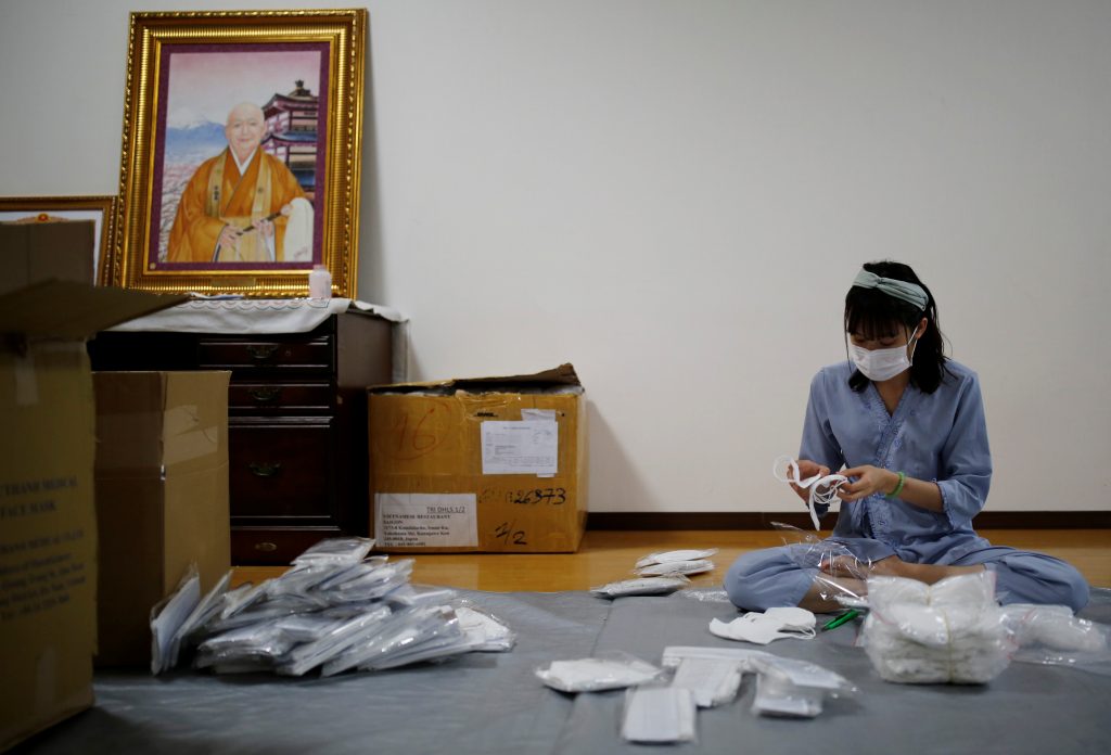 A Vietnamese migrant worker who lost her job amid the coronavirus disease (COVID-19) outbreak, prepares packages of protective masks for Vietnamese people in need and living in Japan at a Buddhist temple which has turned into a shelter for young Vietnamese migrant workers in Tokyo, Japan, July. 2, 2020. (File photo/Reuters)
