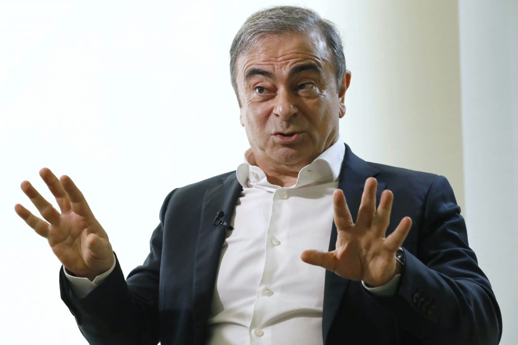 In this Jan. 10, 2020, file photo, former Nissan Chairman Carlos Ghosn speaks to Japanese media during an interview in Beirut, Lebanon. Prosecutors filed documents on Tuesday, July 7, 2020, detailing wire transfers by Ghosn to a company linked to one of the men accused of helping smuggle him out of Japan in a box in 2019. (Meika Fujio/Kyodo News via AP)
