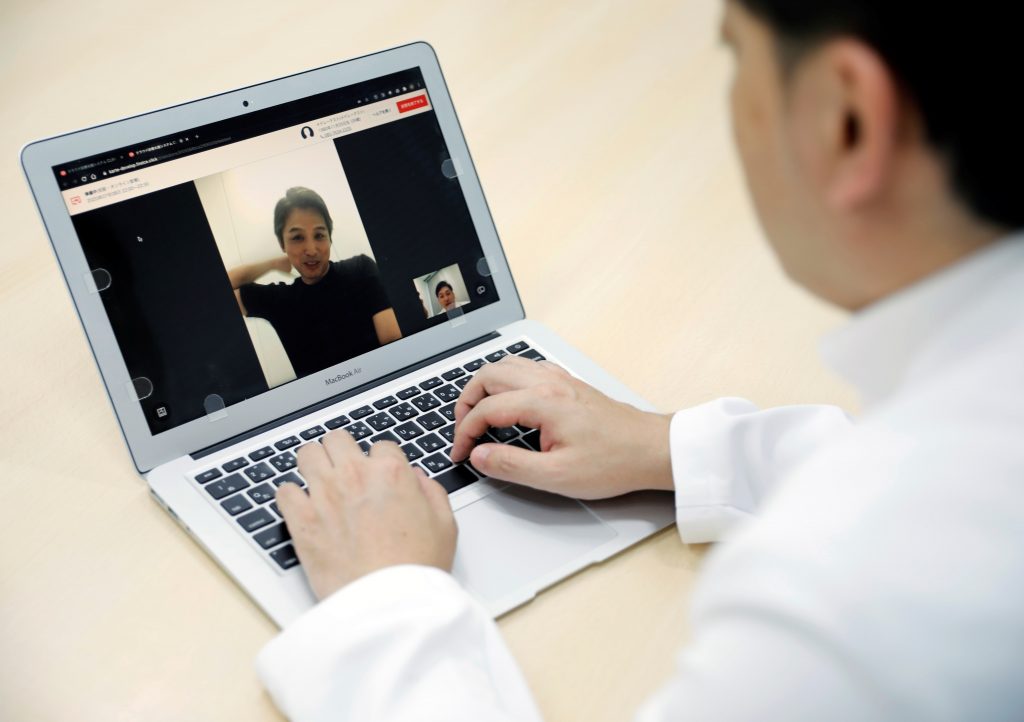 Medical doctor Makoto Kitada demonstrates a telemedicine application service called 'CLINICS', developed by Japanese medical start-up Medley Inc., in Tokyo, Japan, July 8, 2020. (Reuters)