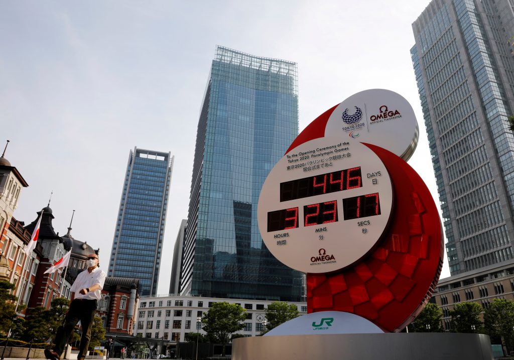 A man wearing a protective mask walks past a countdown clock for the Tokyo 2020 Olympic Games amid the coronavirus disease (COVID-19) outbreak in Tokyo, Japan June 4, 2020. (Reuters)