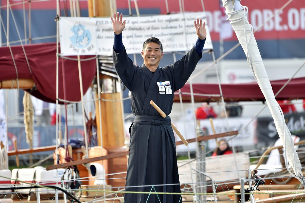 In this file photo taken on November 06, 2016 Japanese skipper Kojiro Shiraishi waves aboard his class Imoca monohull