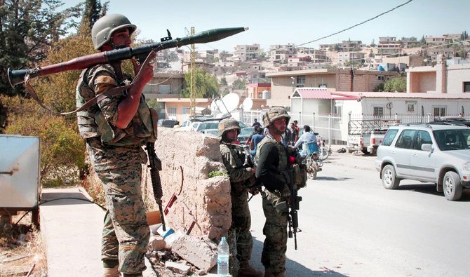 Lebanese troops stand guard in a street in the eastern town of Arsal, on the border with Syria, a day after the Lebanese army began deploying into the town. (AFP/File)