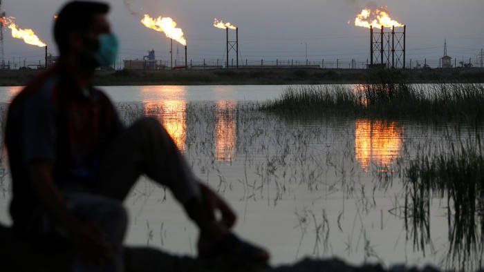 A man near Nahr Bin Umar oilfield, Iraq, wears a protective mask against the coronavirus outbreak. (Reuters)