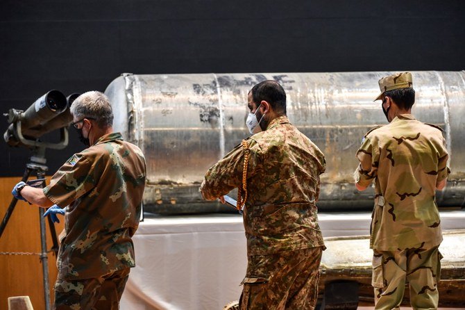 Representatives of the Saudi-led coalition in Yemen take pictures of Iranian weapons seized by Saudi forces from Yemen's Houthis. (AFP/File)