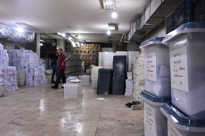 A Syrian man looks at ballot boxes, ahead of handing them over to the police to deliver them to polling stations on the eve of the parliamentary elections. (AFP)