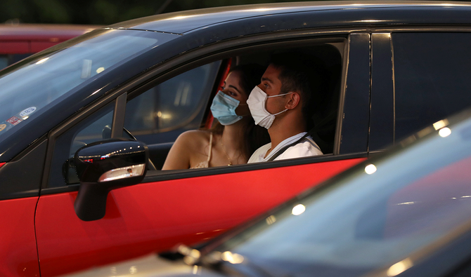 People watch a film from their cars at a drive-in cinema, following the outbreak of COVID-19 in Byblos, Lebanon. (Reuters)