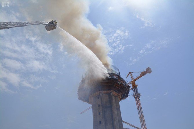 Saudi Civil Defense firefighters suppressing a fire on a tower building in Sakaka on Sunday. (SPA)