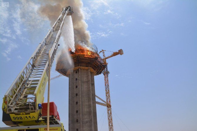 Saudi Civil Defense firefighters suppressing a fire on a tower building in Sakaka on Sunday. (SPA)