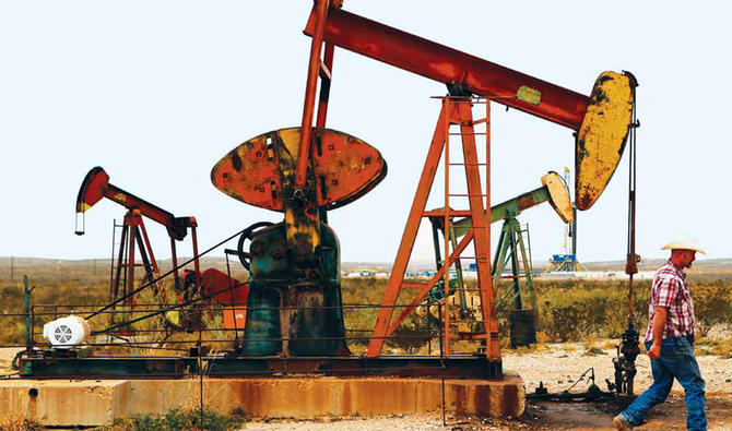 A rancher walks past a pump jack in Loving County, Texas. Brent is on track for a fourth straight monthly gain in July and WTI is set to rise for a third month. (Reuters/File)