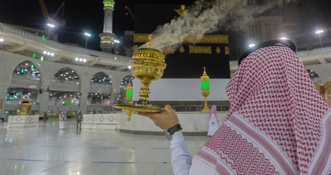 A Hajj official burns incense at Makkah’s Grand Mosque as a few pilgrims circumambulate the Kaaba. The pilgrimage has been downsized due to COVID-19. (Reuters)